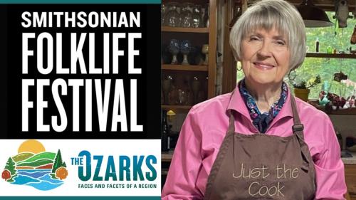 A woman in an apron smiles.