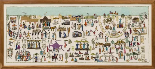 A wooden-framed, horizontal, rectangular cloth of detailed embroidery depicts detailed colorful scenes of people dancing, crafting, playing music, feeding animals, and other activities.