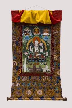 A painted scroll of a Buddhist figure surrounded by objects and landscapes, including many Washington, D.C., landmarks, is mounted on a brocade flower background of rich colors.